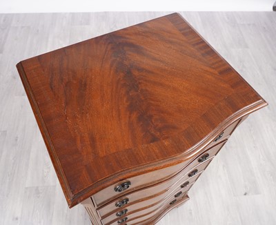 Lot 31 - A reproduction serpentine fronted tall chest of six drawers