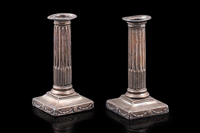Lot 101 - A pair of George III short silver candlesticks