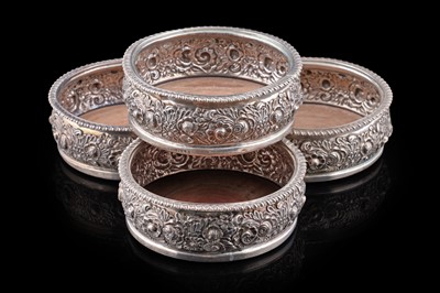 Lot 104 - A set of four George III silver wine coasters