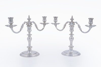 Lot 9 - A matched pair of Elizabeth II cast silver twin-light candelabra