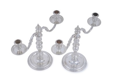 Lot 9 - A matched pair of Elizabeth II cast silver twin-light candelabra