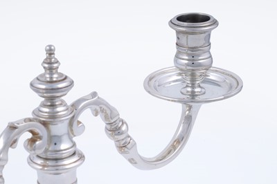 Lot 9 - A matched pair of Elizabeth II cast silver twin-light candelabra