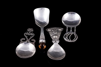 Lot 139 - Four silver caddy spoons, Scottish and Scottish-themed