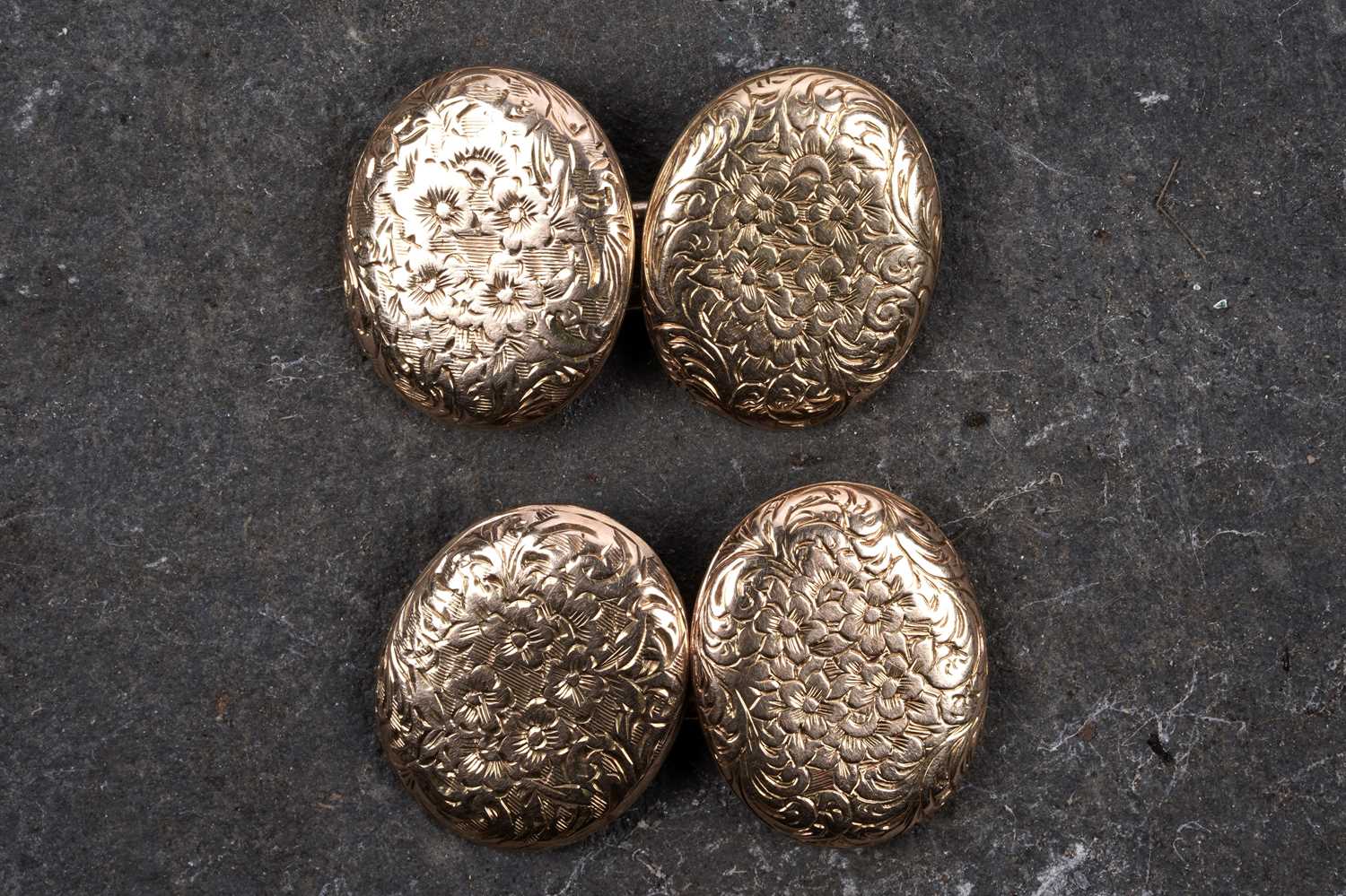 Lot 68 - A pair of Edwardian gold cuff links with engraved floral decoration