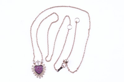 Lot 405 - A modern ruby and diamond flaming heart pendant