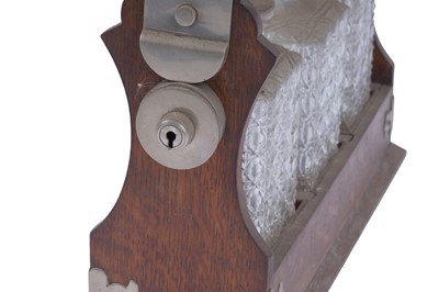 Lot 218 - An Edwardian oak three bottle tantalus