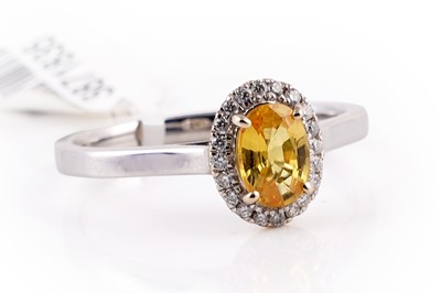 Lot 421 - A contemporary Iliana Chanthaburi yellow sapphire and diamond halo ring