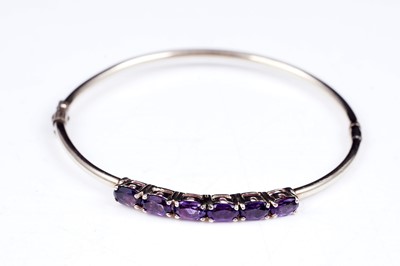 Lot 2 - A modern amethyst hinged bangle