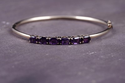 Lot 2 - A modern amethyst hinged bangle