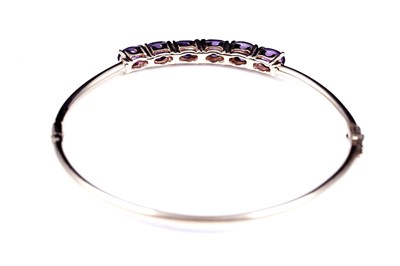 Lot 2 - A modern amethyst hinged bangle