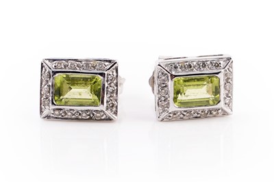 Lot 437 - A pair of peridot and diamond stud earrings