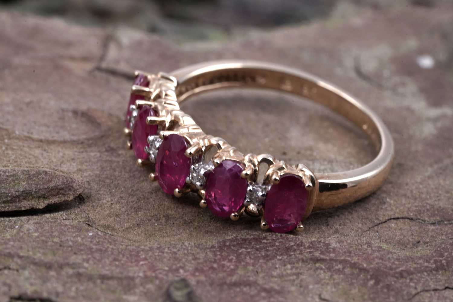 Lot 43 - A ruby and diamond half hoop eternity ring