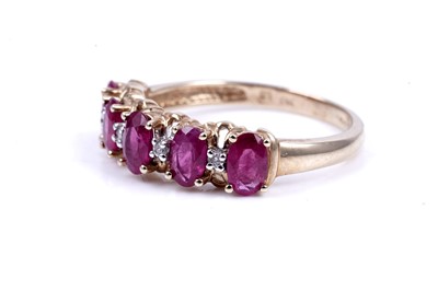 Lot 43 - A ruby and diamond half hoop eternity ring