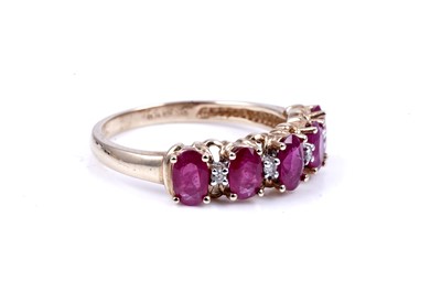 Lot 43 - A ruby and diamond half hoop eternity ring