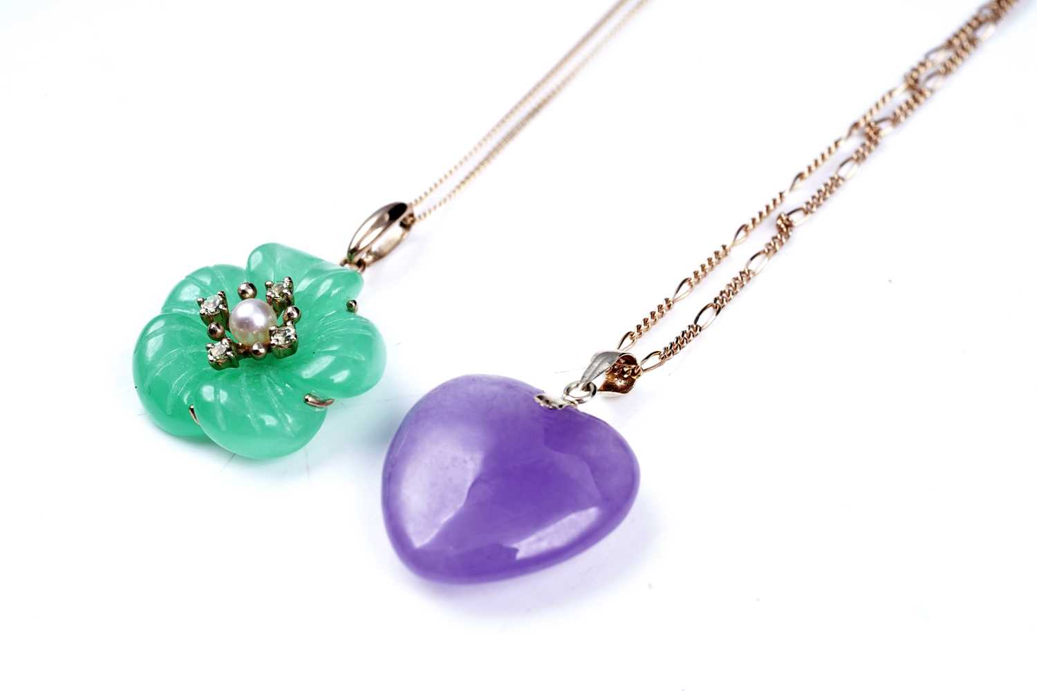 Lot 59 - A jade and yellow tourmaline flower pattern pendant; and a loveheart pendant on chain