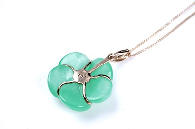 Lot 59 - A jade and yellow tourmaline flower pattern pendant; and a loveheart pendant on chain