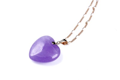 Lot 59 - A jade and yellow tourmaline flower pattern pendant; and a loveheart pendant on chain