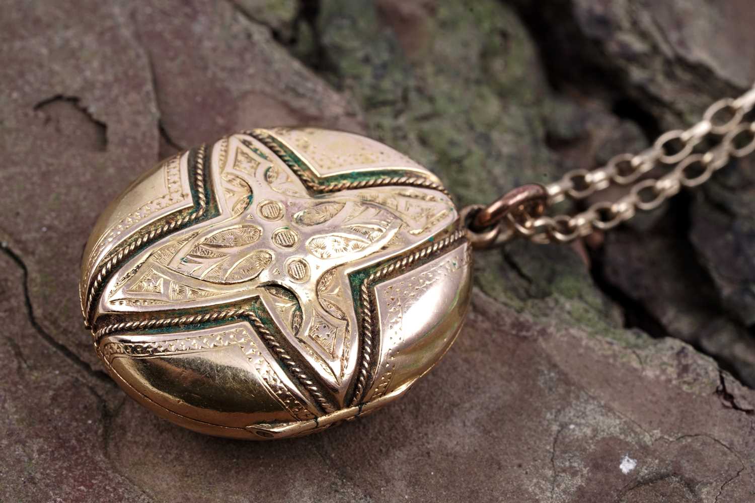 Lot 21 - A Victorian Gothic Revival locket on a 9ct gold fancy-link chain