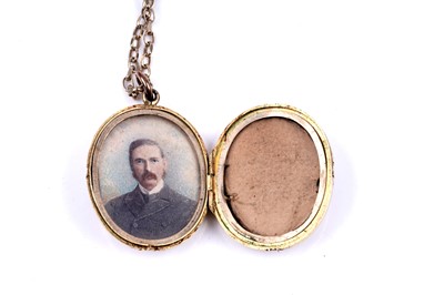 Lot 21 - A Victorian Gothic Revival locket on a 9ct gold fancy-link chain