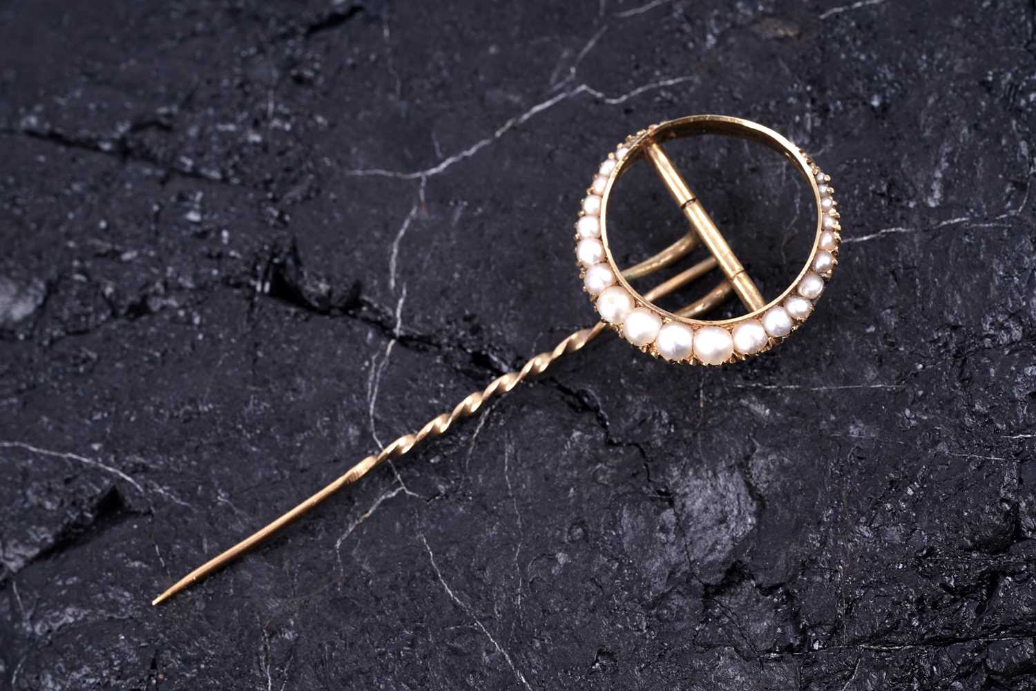 Lot 24 - An Edwardian crescent moon pattern stick pin set with seed pearls
