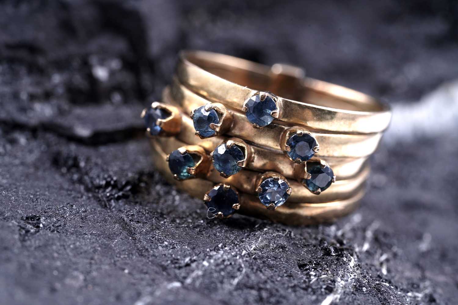 Lot 83 - A modern green and blue sapphire articulated ring