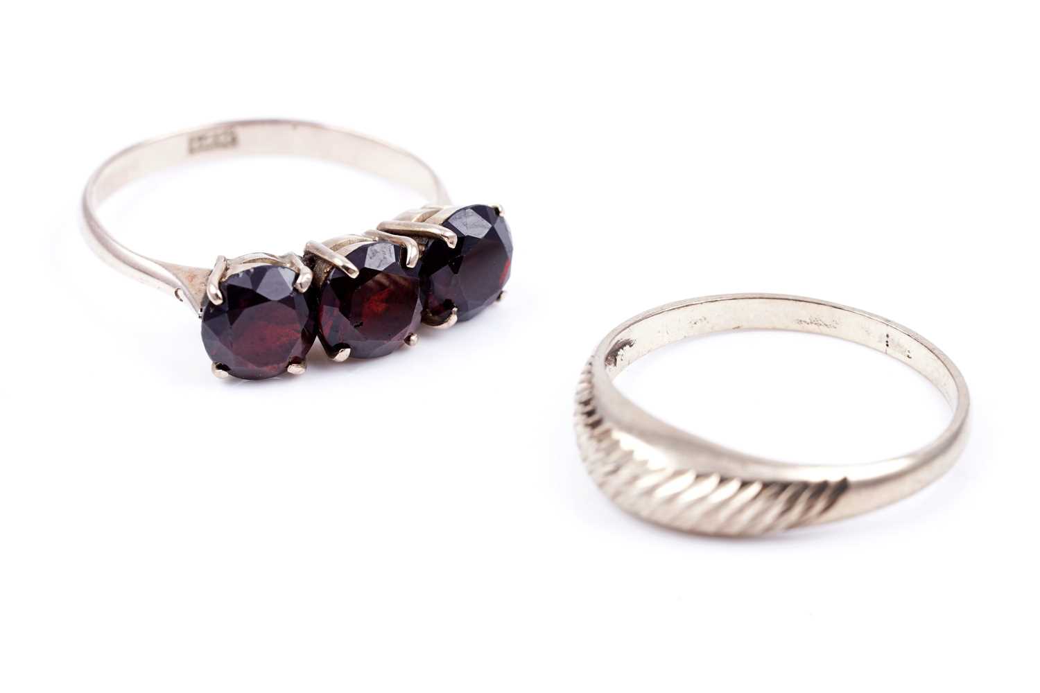 Lot 96 - A three stone garnet ring; and a modern 9ct gold ring