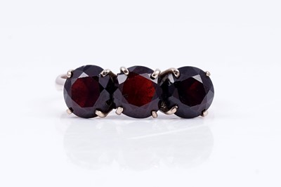 Lot 96 - A three stone garnet ring; and a modern 9ct gold ring