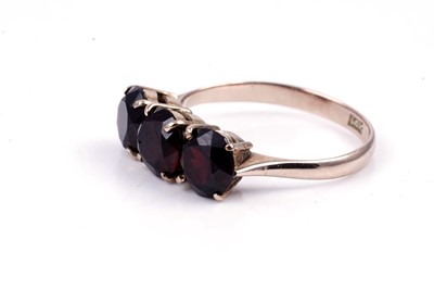 Lot 96 - A three stone garnet ring; and a modern 9ct gold ring