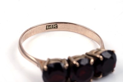 Lot 96 - A three stone garnet ring; and a modern 9ct gold ring
