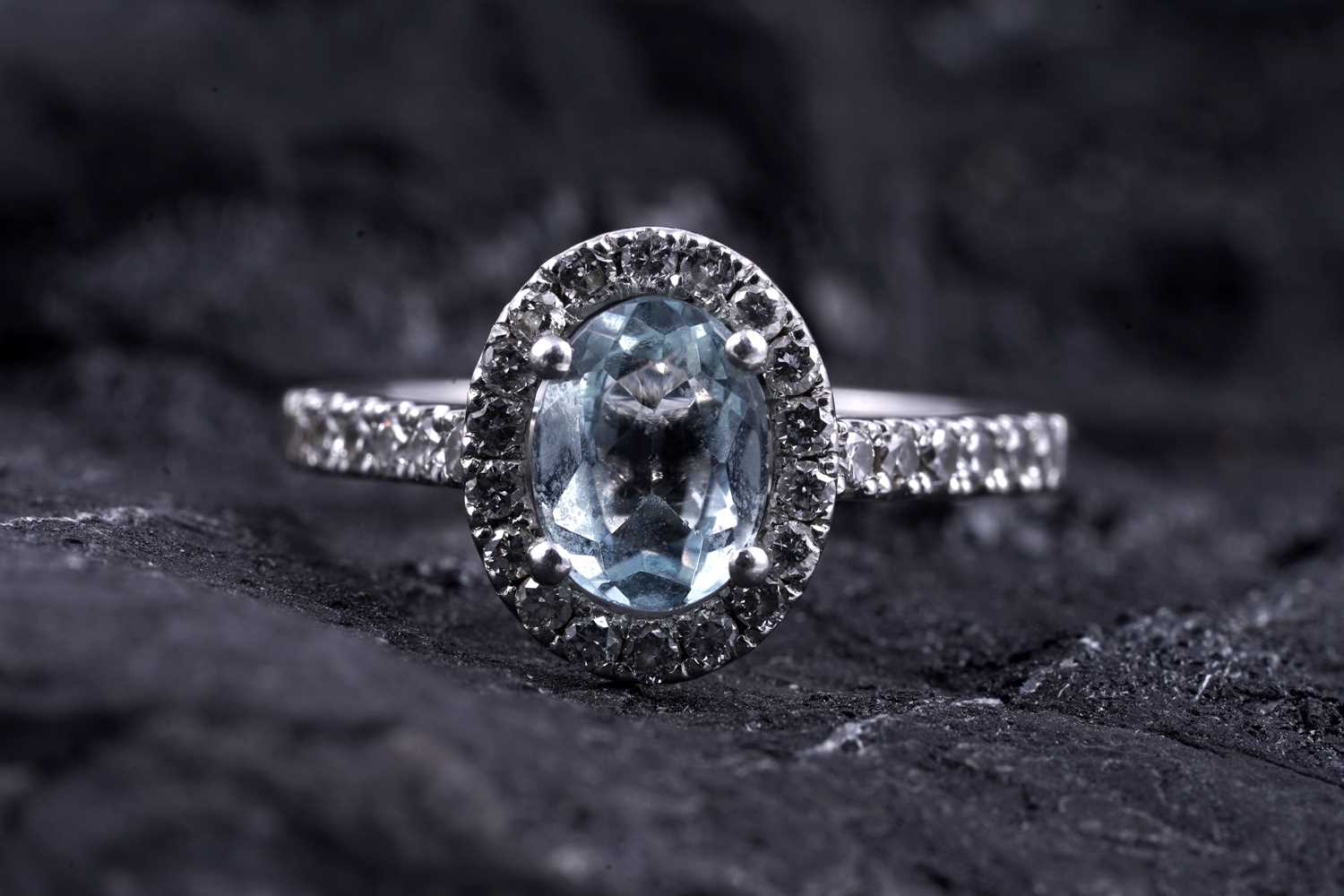 Lot 24 - An aquamarine and diamond cluster ring