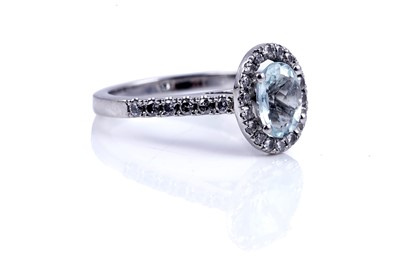 Lot 24 - An aquamarine and diamond cluster ring