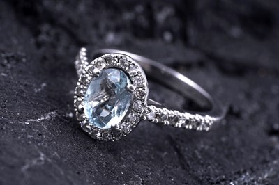 Lot 24 - An aquamarine and diamond cluster ring