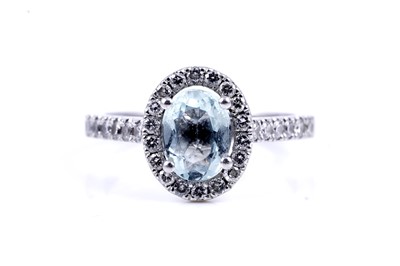 Lot 24 - An aquamarine and diamond cluster ring