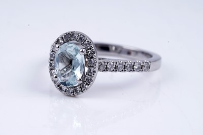 Lot 24 - An aquamarine and diamond cluster ring