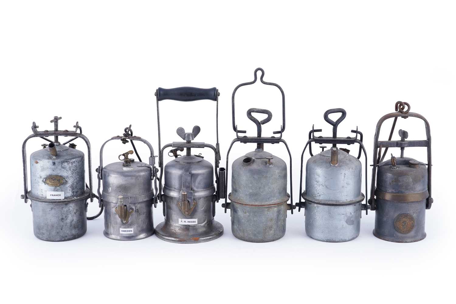 Lot 231 - A collection of six early 20th Century carbide lamps