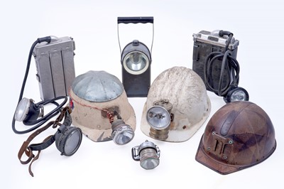 Lot 159 - Three helmets; and a collection of electric lights