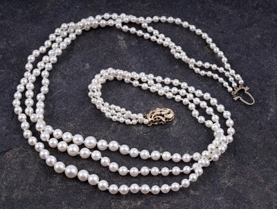 Lot 521 - A three-row cultured pearl necklace with diamond set clasp