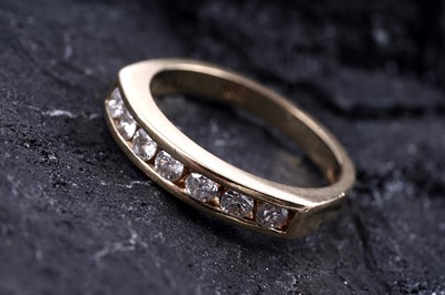 Lot 462 - A seven-stone diamond half-hoop eternity ring