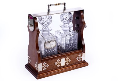 Lot 184 - A mahogany and silver plate two decanter tantalus