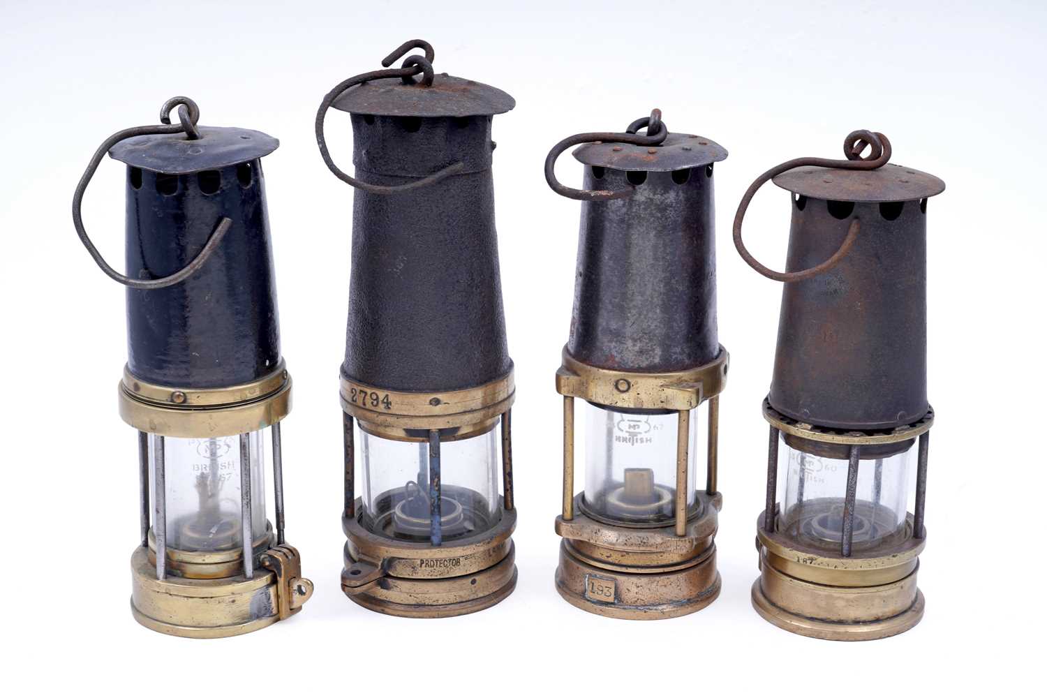 Lot 233 - Four ‘Protector’ type miners’ lamps