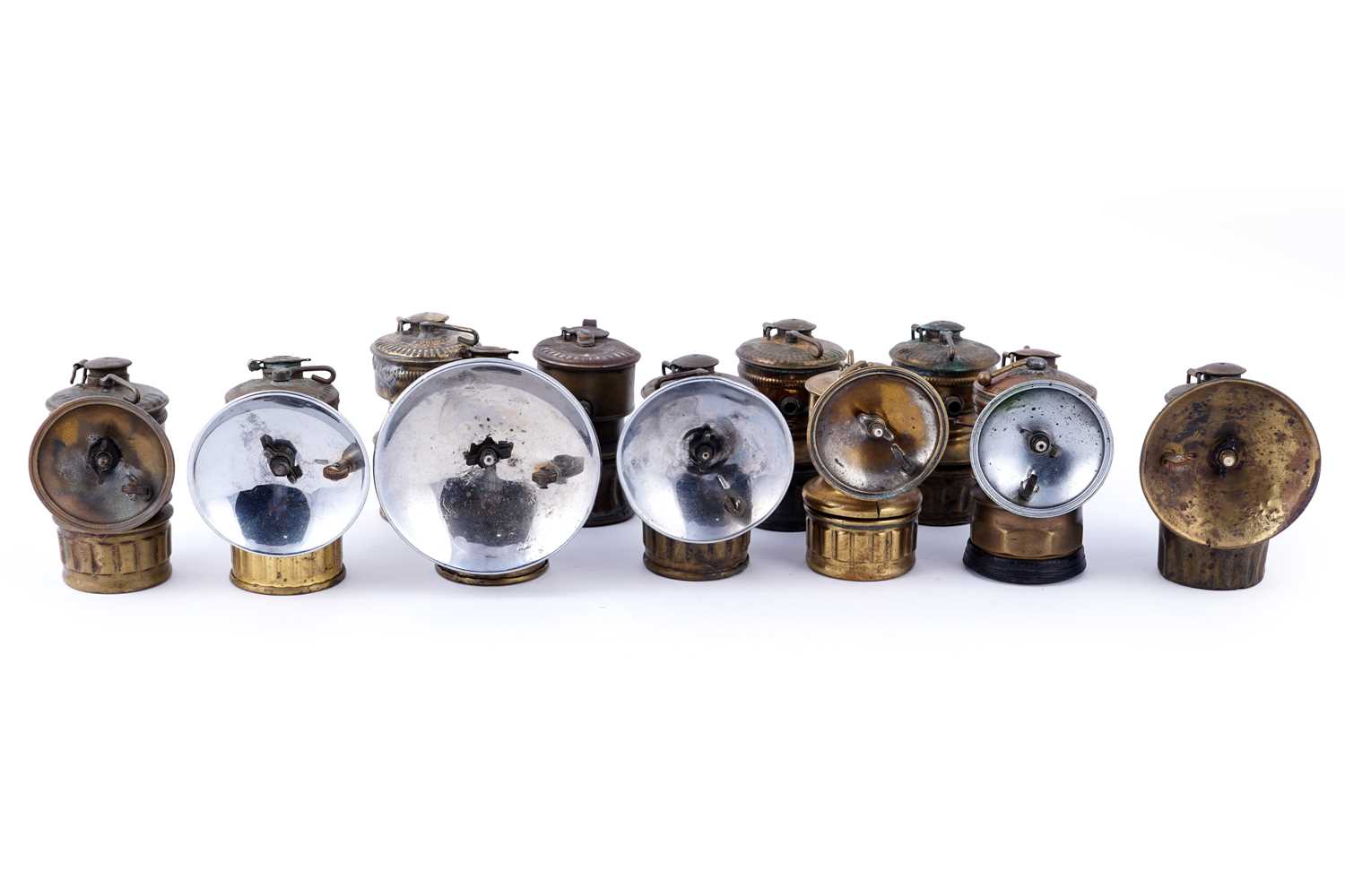 Lot 209 - A collection of brass ‘Guys Dropper’ type carbide lamps