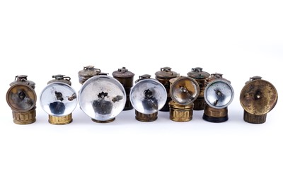 Lot 209 - A collection of brass ‘Guys Dropper’ type carbide lamps