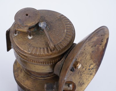 Lot 209 - A collection of brass ‘Guys Dropper’ type carbide lamps