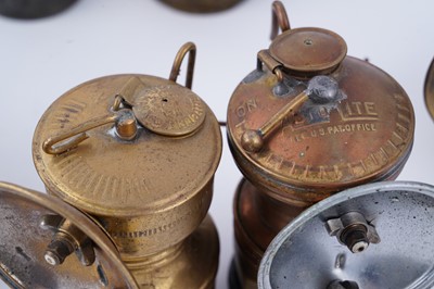 Lot 209 - A collection of brass ‘Guys Dropper’ type carbide lamps