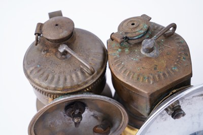 Lot 209 - A collection of brass ‘Guys Dropper’ type carbide lamps