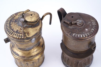 Lot 209 - A collection of brass ‘Guys Dropper’ type carbide lamps