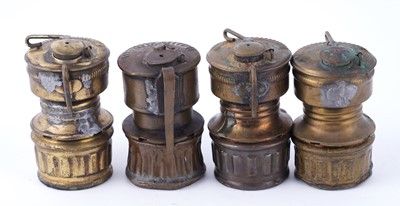 Lot 209 - A collection of brass ‘Guys Dropper’ type carbide lamps
