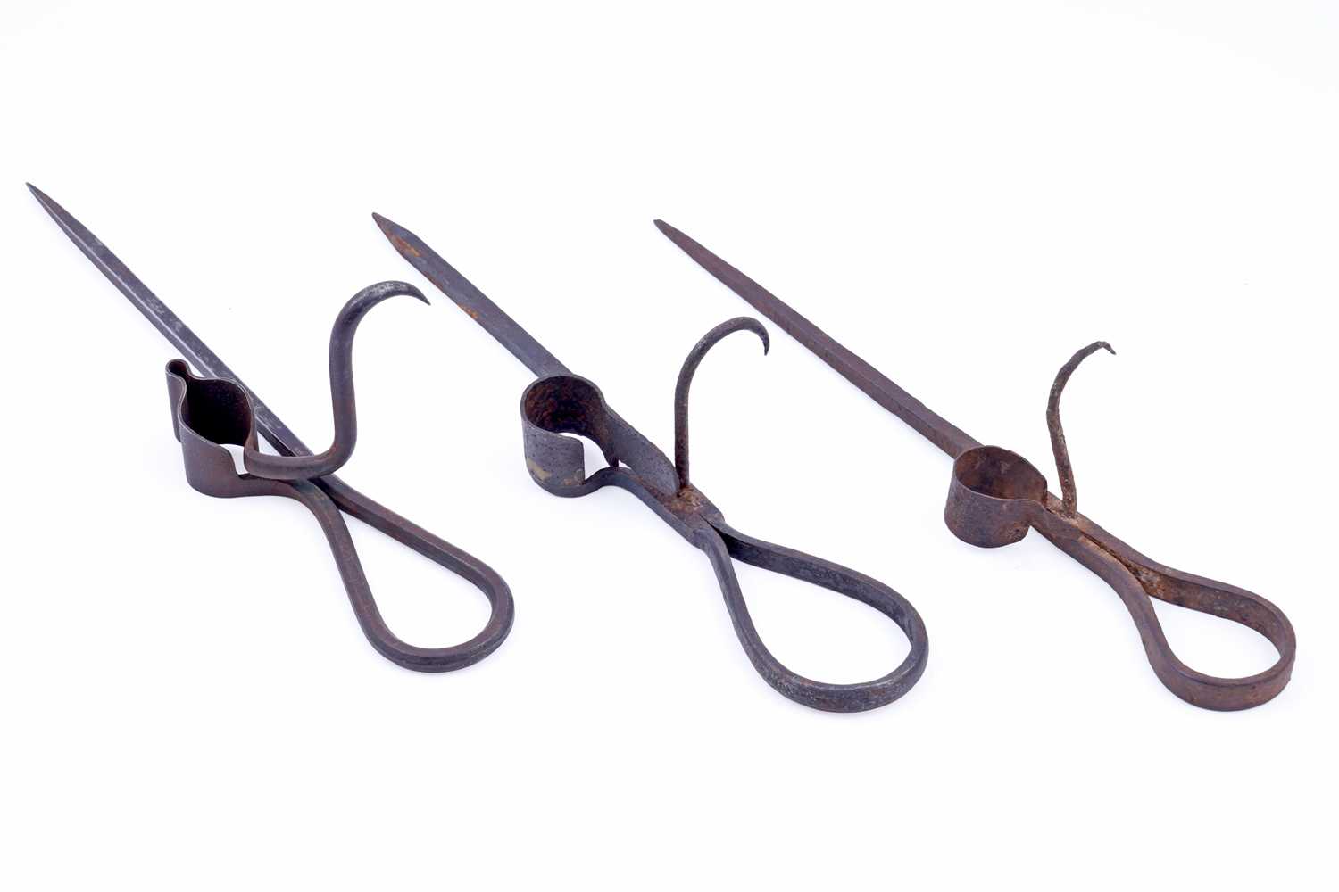 Lot 207 - Two 19th Century wrought iron ‘Sticking Tommy’ candle holders; and another