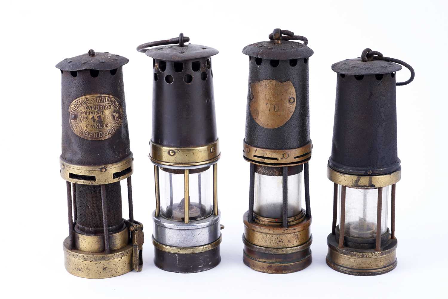 Lot 185 - A collection of four ‘Protector’ type lamps