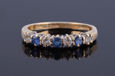 Lot 444 - A modern sapphire and diamond half-hoop eternity ring